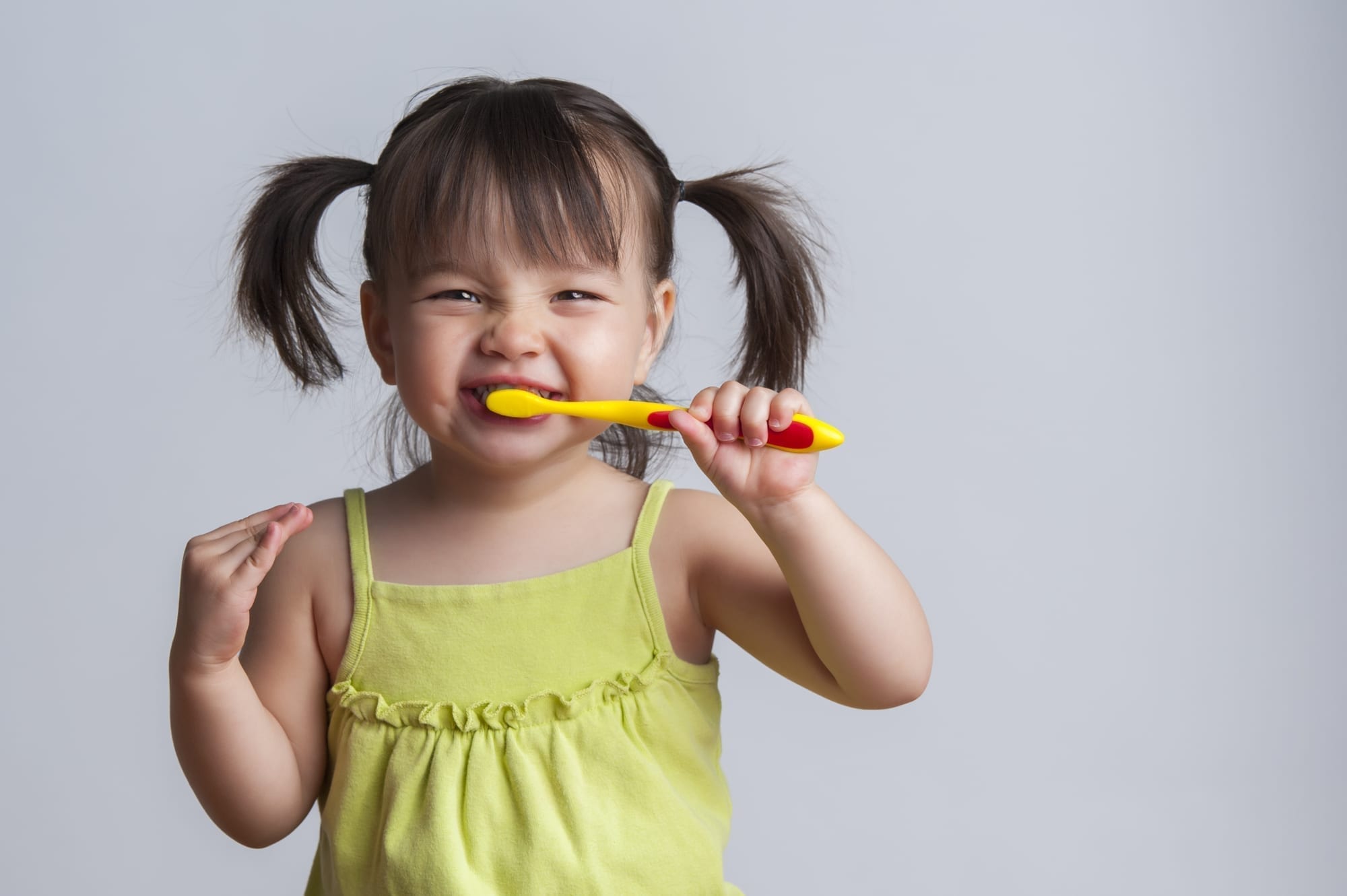 little girl brushing teeth