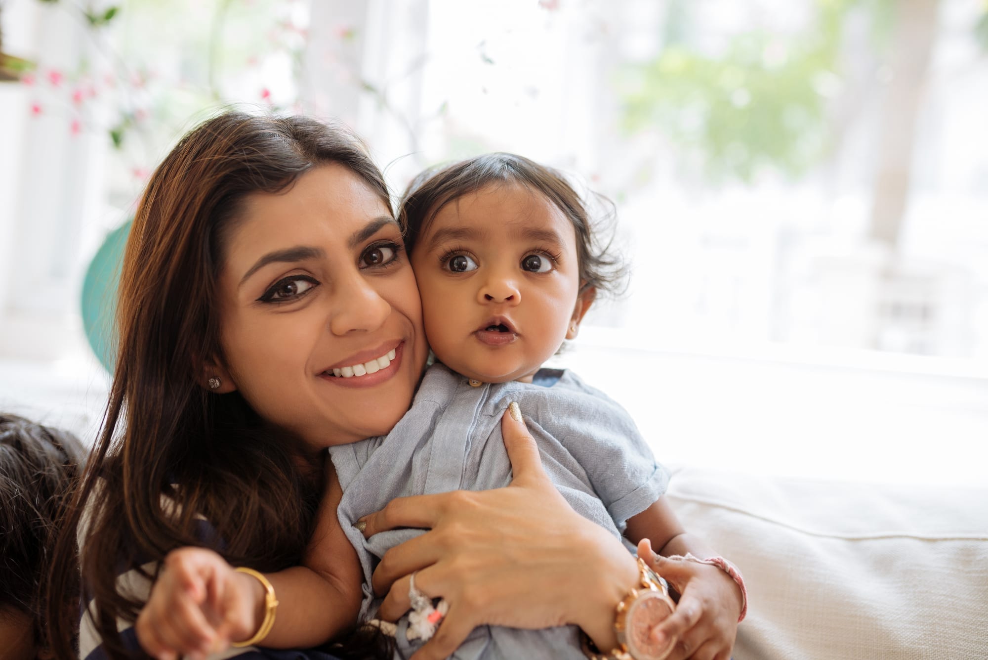 mother and toddler smiling at camera