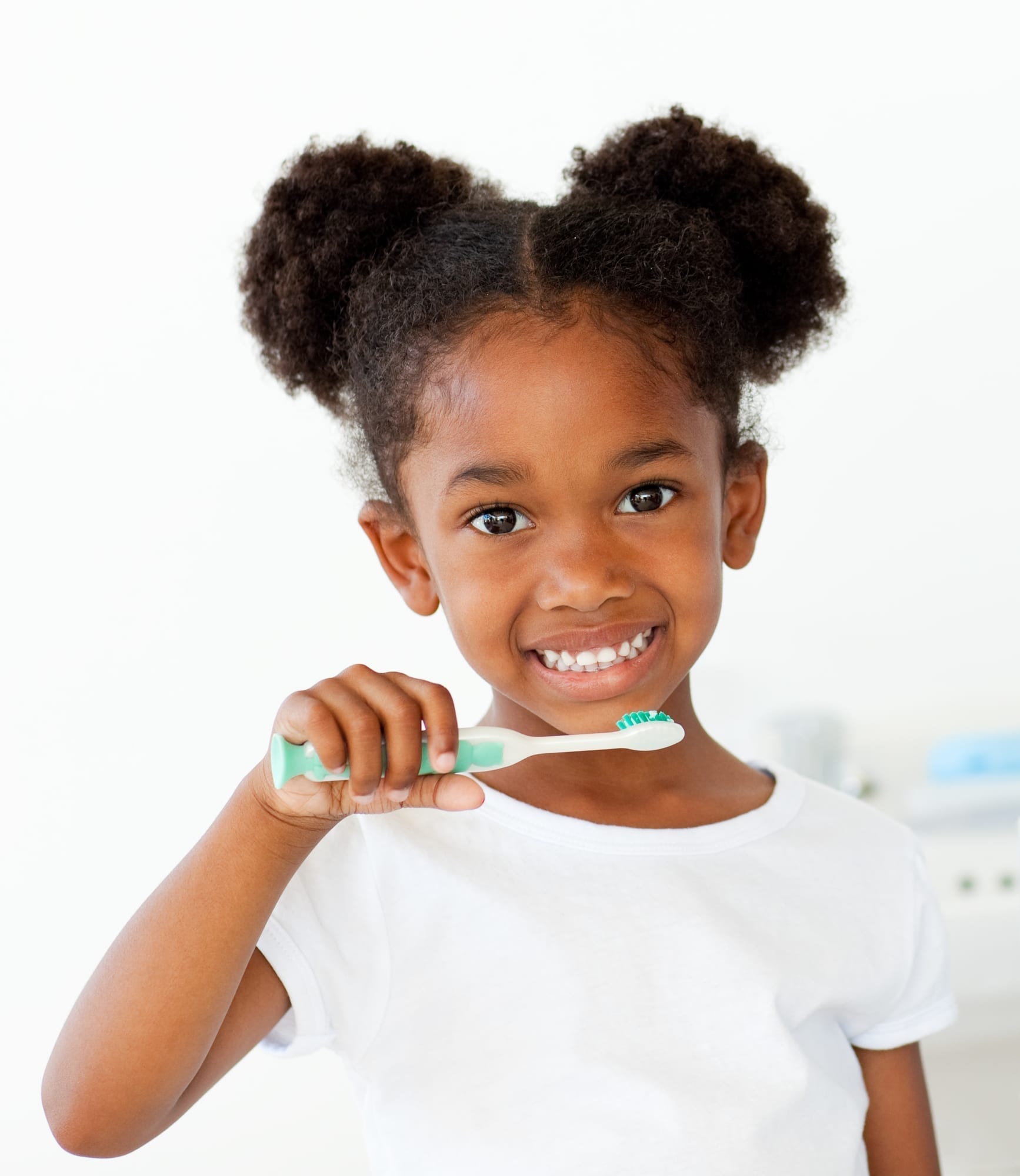 little girl holding toothbrush