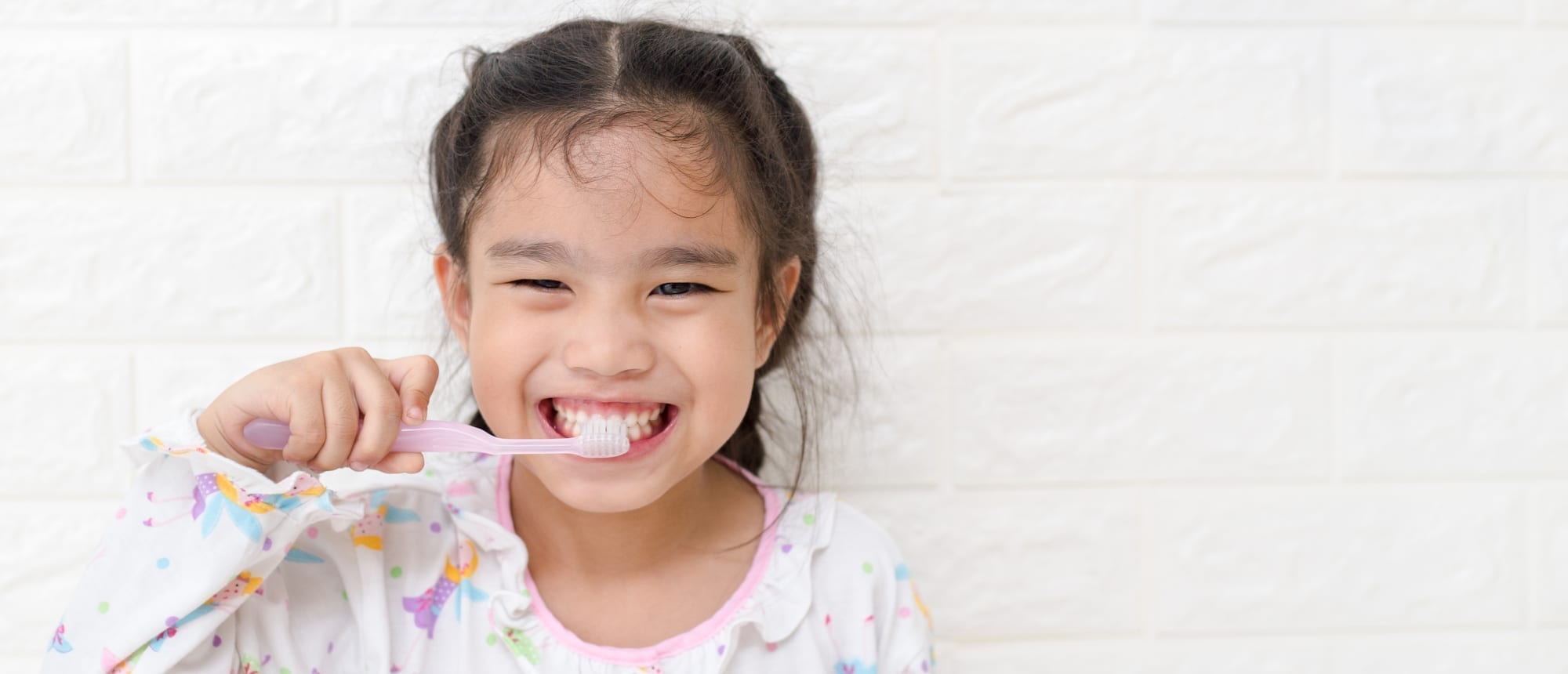 little girl brushing teeth