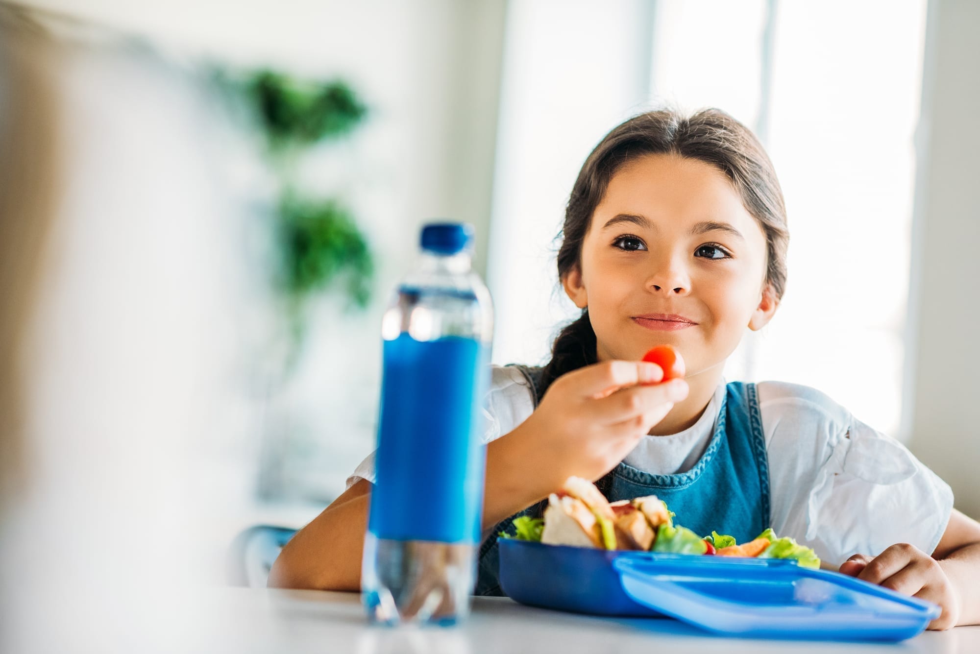 young girl eating lunch