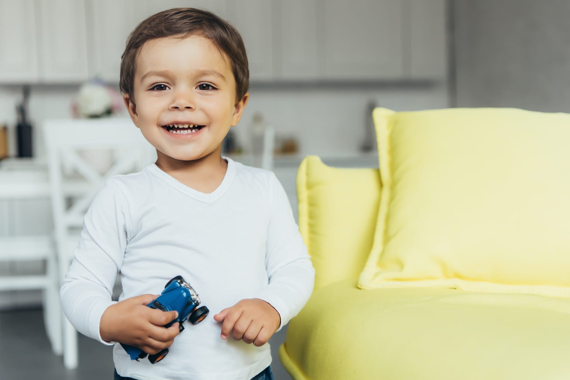 happy toddler with toy car