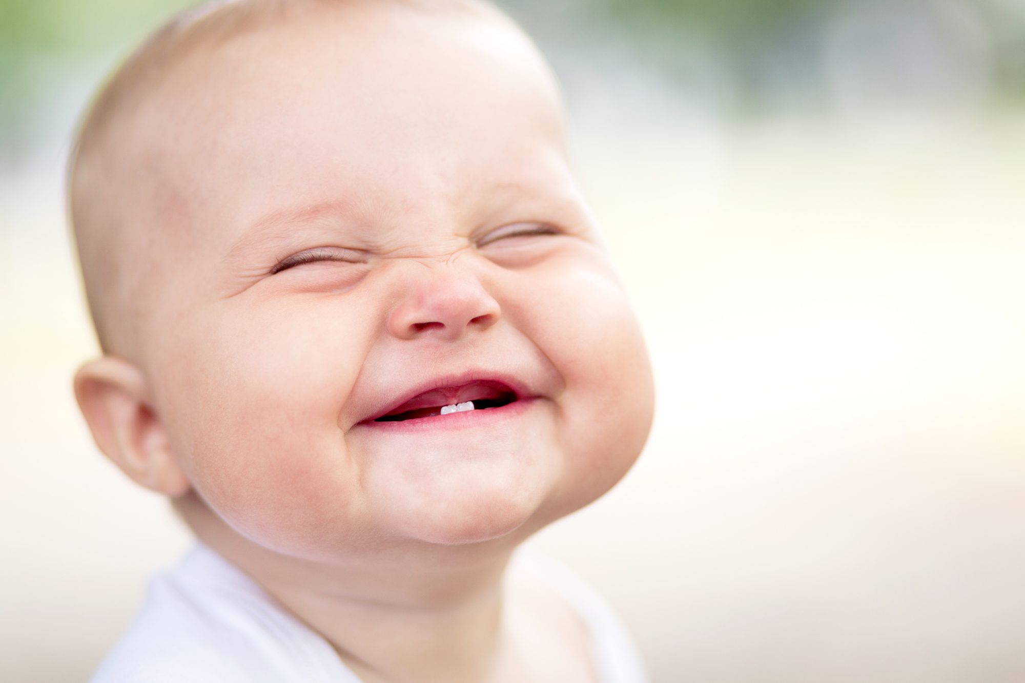 cute baby smiling with two baby teeth