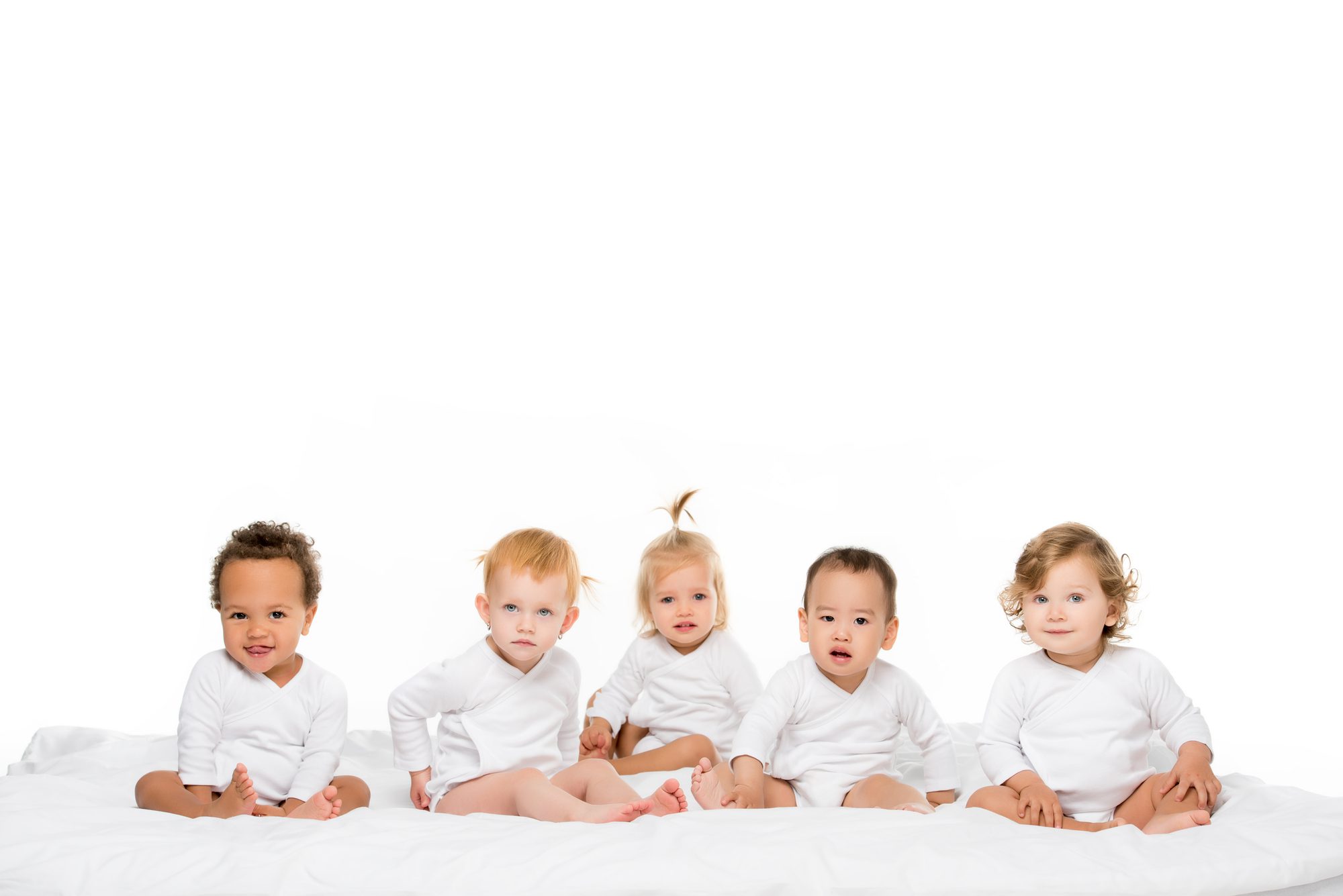 five babies in white long-sleeved onesies who need dental care tips