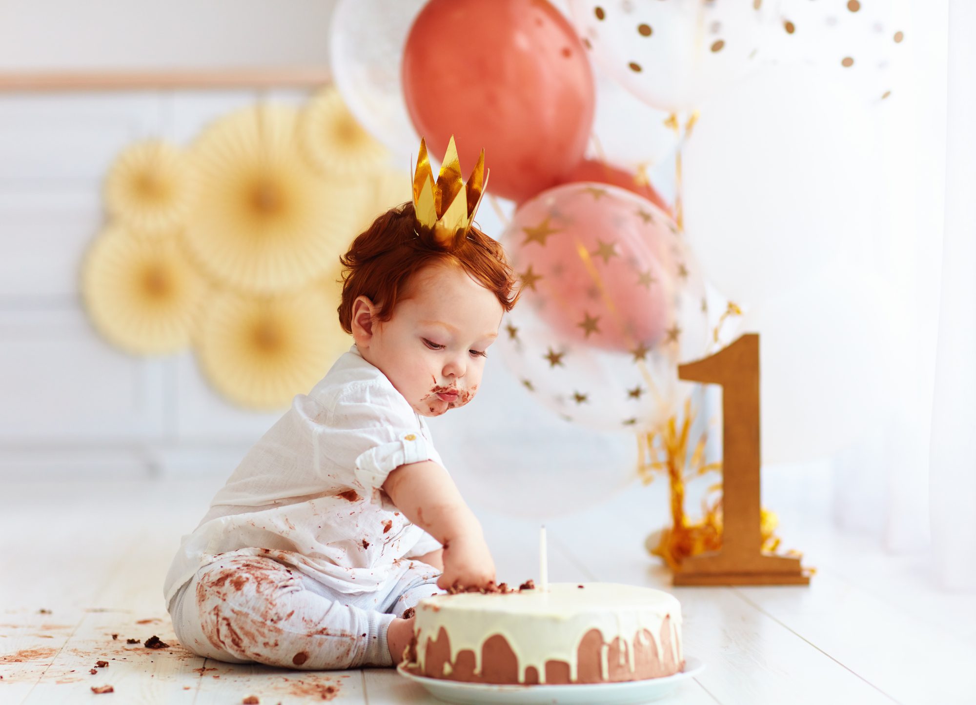 baby celebrating first birthday which means it's time for his or her first dental appointment