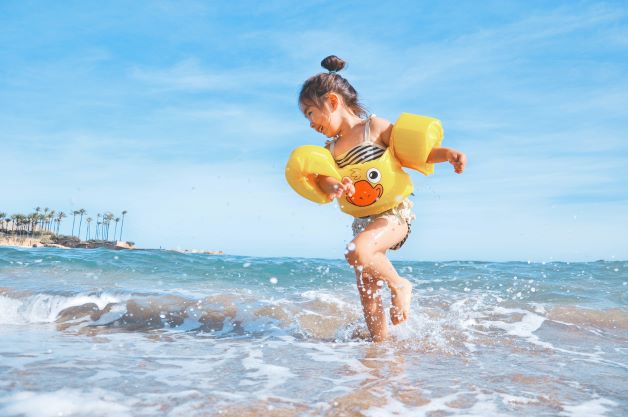 little girl playing in the sun and getting vitamin D to support dental health