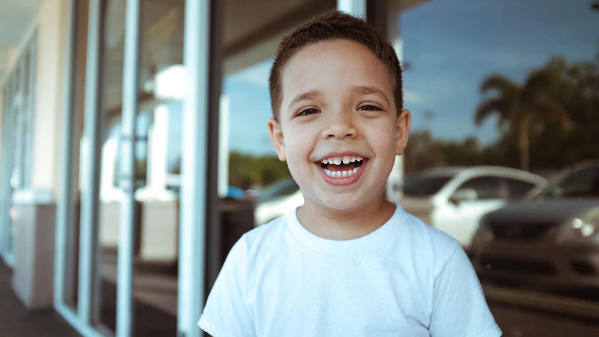 Smiling Boy in a Parking Lot