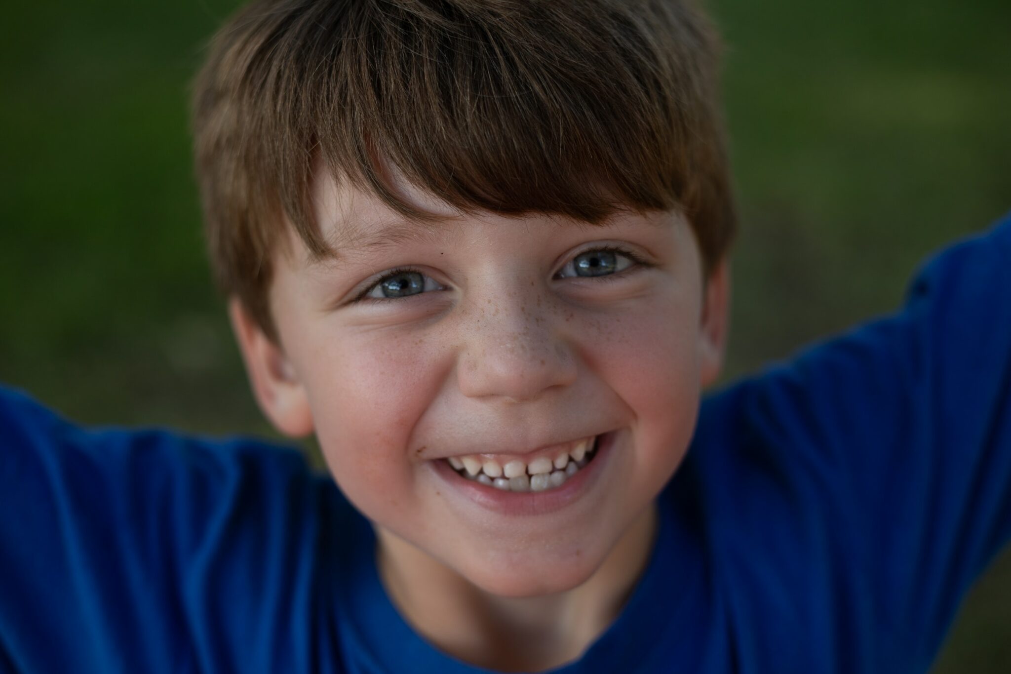 Freckled little boy in a blue shirt