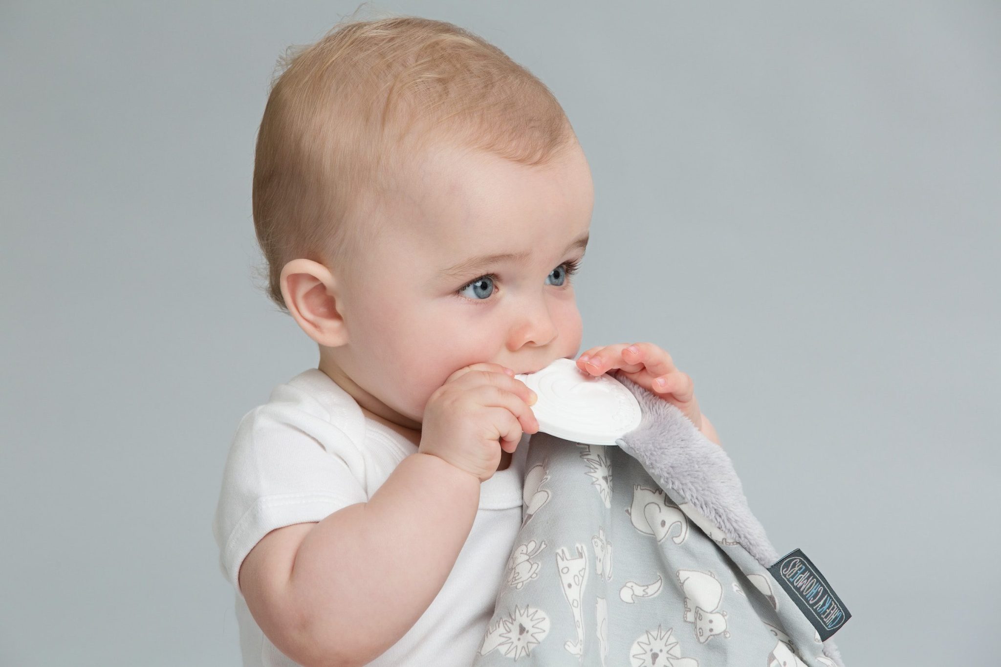 Baby chewing on a blanket