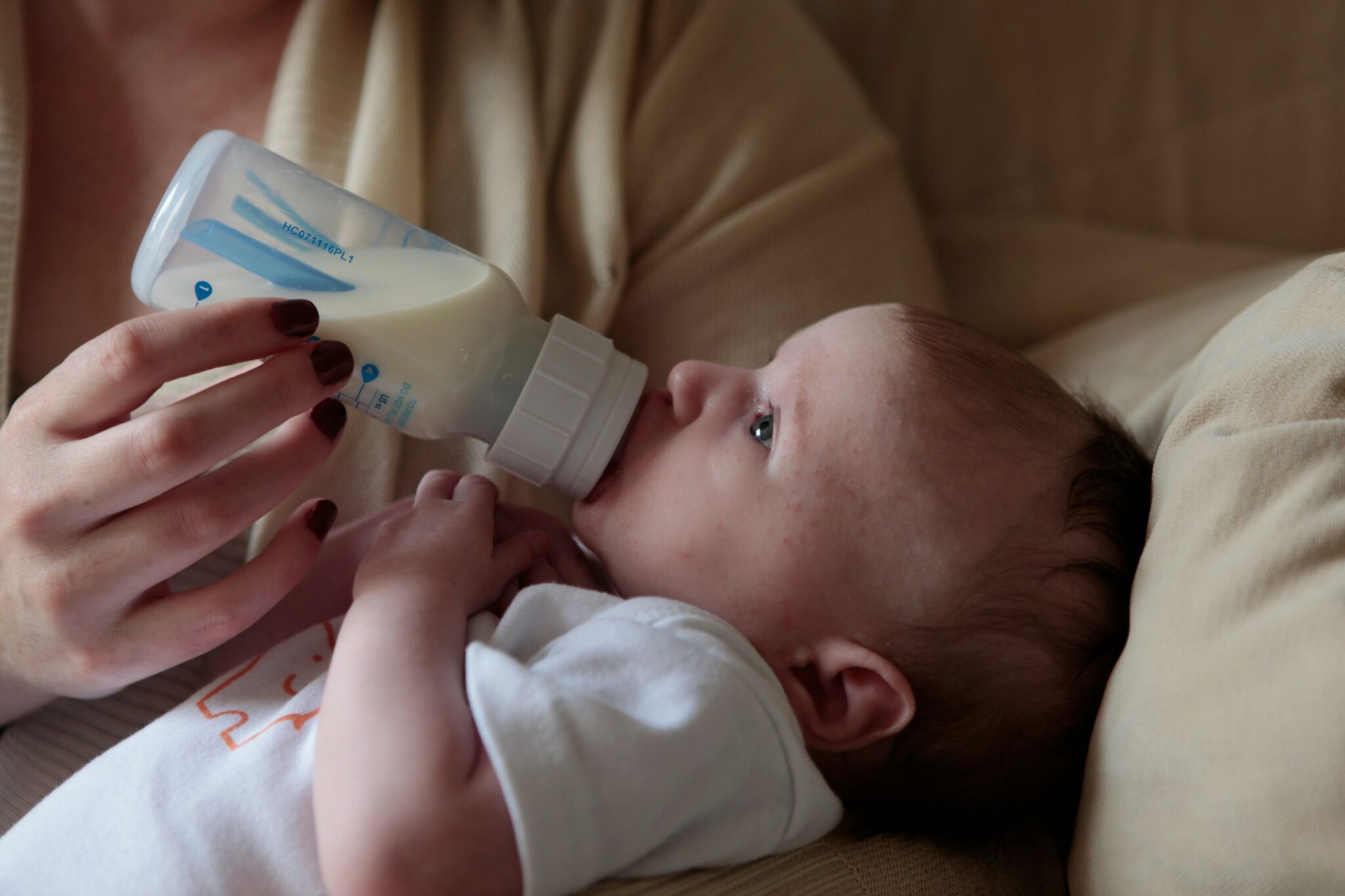 Woman feeding baby with a bottle